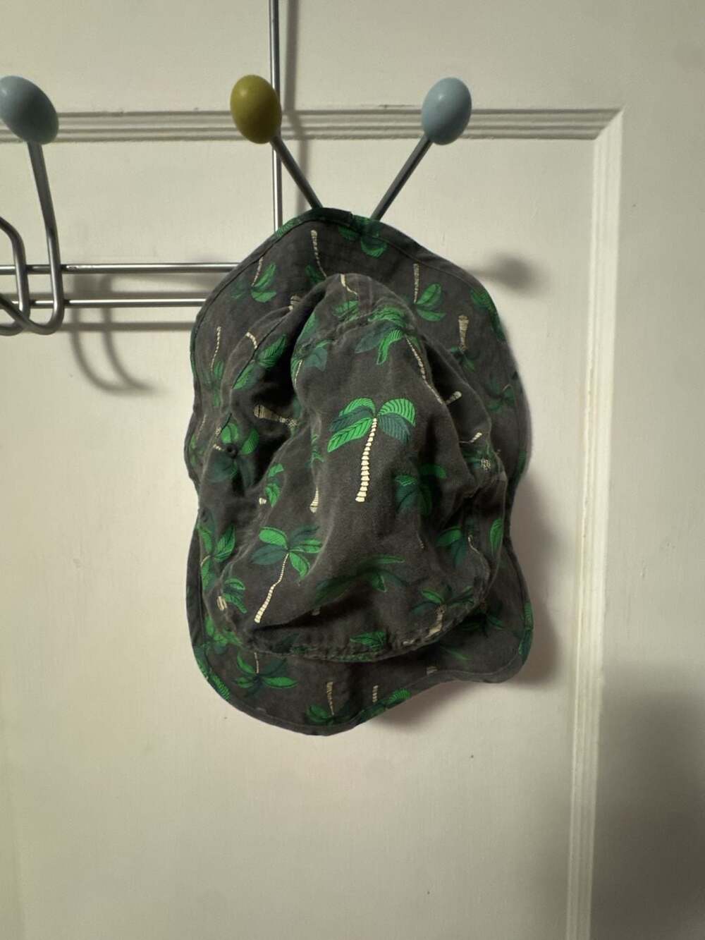 Rip Curl grey bucket hat with green palm tree print